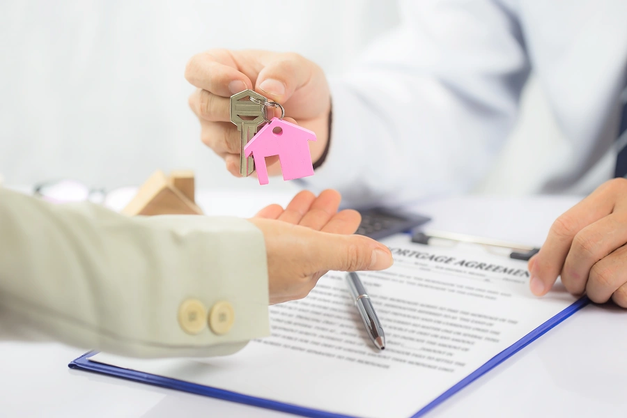 Signing mortgage agreement with keys