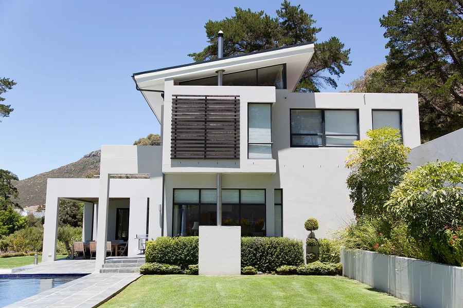 Contemporary home with pool and greenery