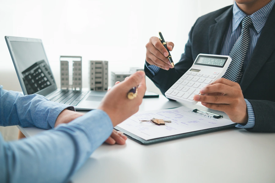 Business meeting with calculator and documents