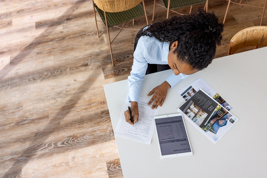 Businesswoman working with tablet and papers