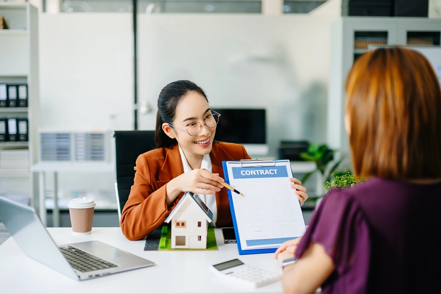Real estate agent showing contract to client.