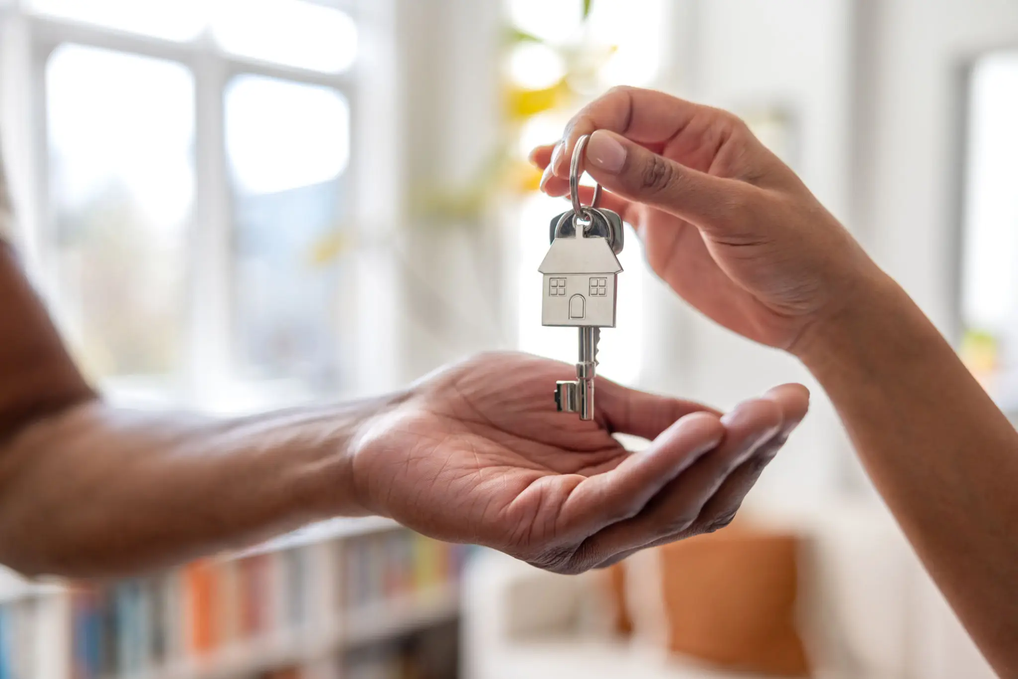 Handing house keys to new homeowner