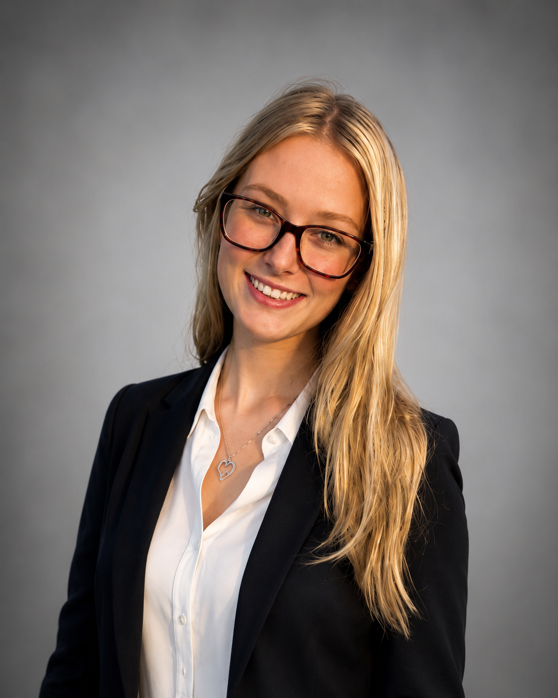 Smiling professional headshot with glasses