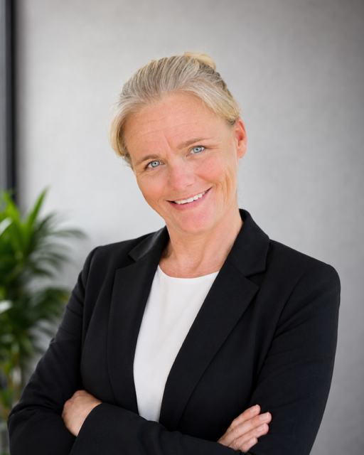 Smiling businesswoman with arms crossed