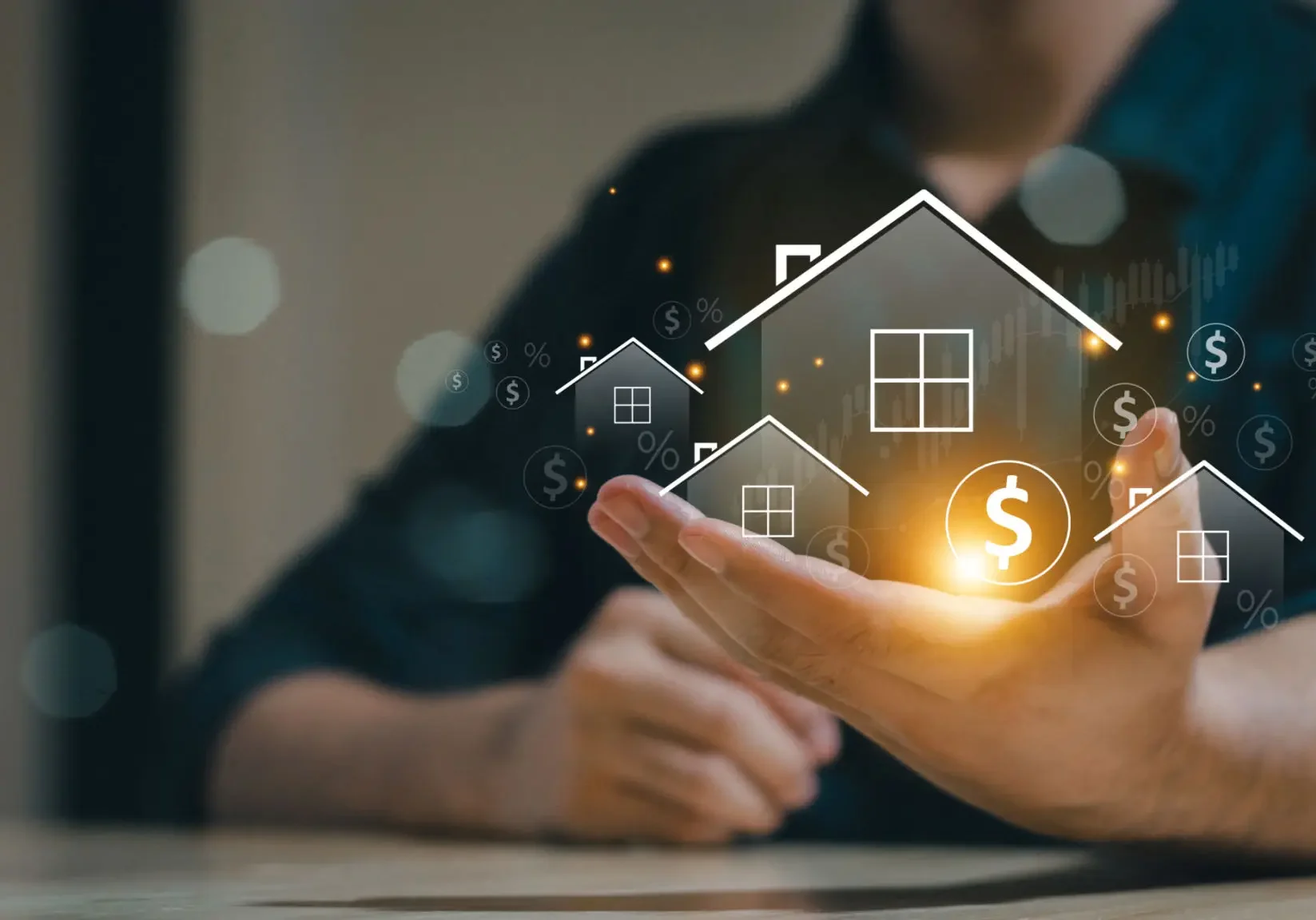 Hand holding glowing house icons with dollar symbols