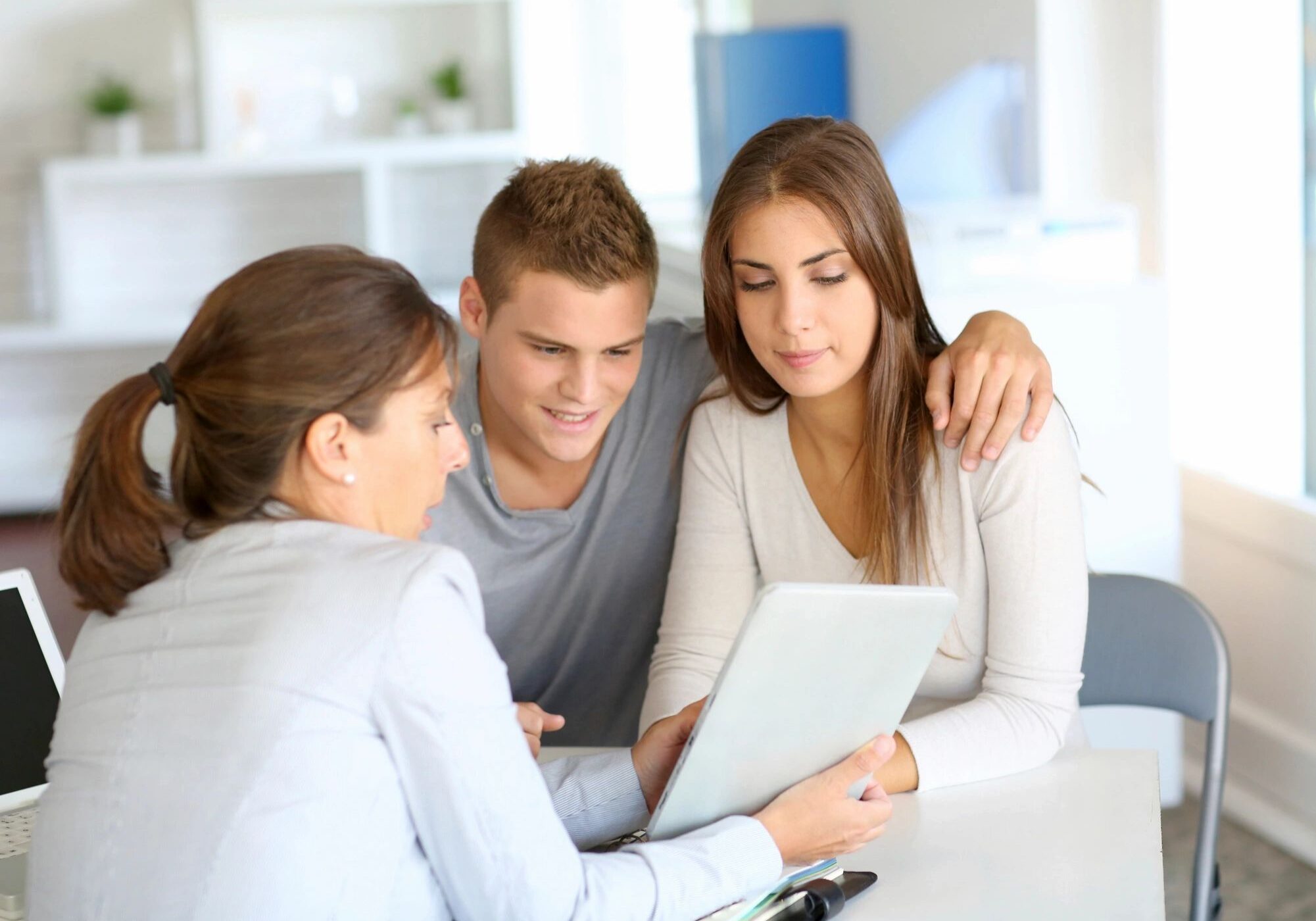Three people looking at tablet together